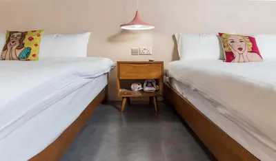 two beds sitting next to each other in a room at Abu Siti George Town in George Town