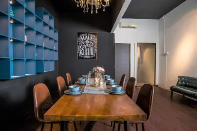 a dining room with a wooden table and chairs at Abu Siti George Town in George Town