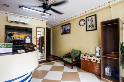 a restaurant lobby with a clock on the wall at OYO 89549 Casavilla Hotel (city Centre) Taiping in Taiping