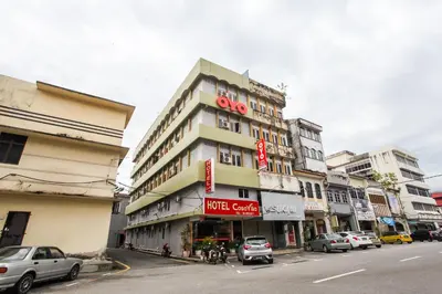 a tall building with a sign on it on a street at OYO 89549 Casavilla Hotel (city Centre) Taiping in Taiping