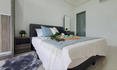 a bedroom with a large bed with a tray on it at Ipoh Meru Casa Kayangan by BeeStay in Ipoh