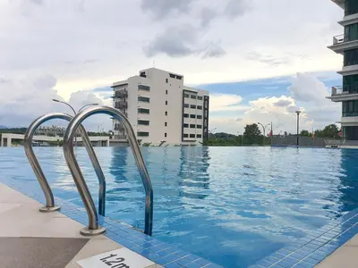 a swimming pool with a building in the background at Ipoh Meru Casa Kayangan by BeeStay in Ipoh