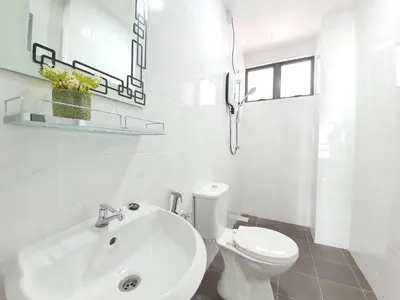 a white bathroom with a sink and a toilet at Ipoh Meru Casa Kayangan by BeeStay in Ipoh