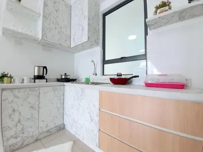 a kitchen with a counter with a window at Ipoh Meru Casa Kayangan by BeeStay in Ipoh