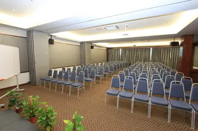 a conference room with chairs and a white screen at Ipoh Downtown Hotel in Ipoh
