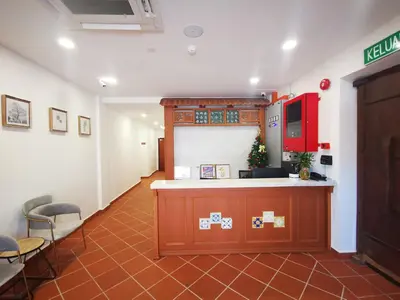 a waiting room with a counter and some chairs at Mclane Boutique Hotel in George Town