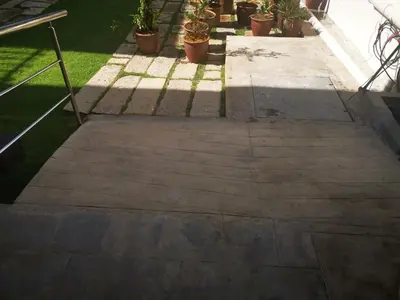 a concrete walkway with potted plants on it at Mclane Boutique Hotel in George Town