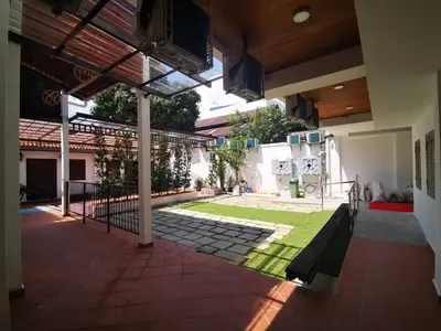 a courtyard of a house with a green lawn at Mclane Boutique Hotel in George Town