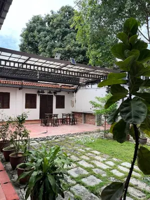 a house with a patio with tables and chairs at Mclane Boutique Hotel in George Town