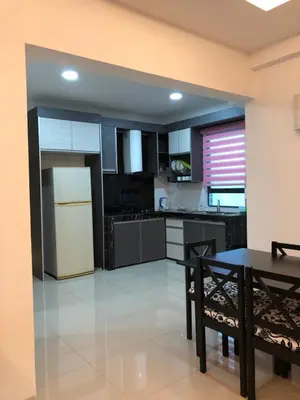 a kitchen with a table and a white refrigerator at KJ Homestay Casa Kayangan in Ipoh
