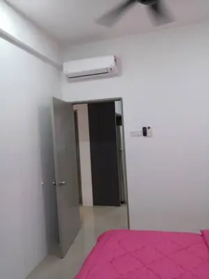 a bedroom with a pink bed and a door at KJ Homestay Casa Kayangan in Ipoh