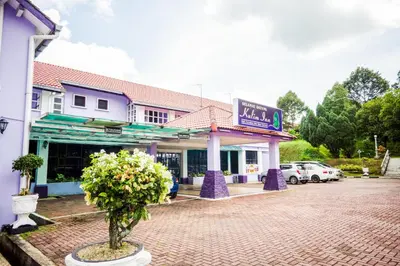 a small tree in front of a building at Hotel O Kulim Inn in Kulim