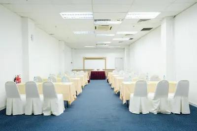 a conference room with tables and chairs in it at Raia Inn Penang in Bayan Lepas