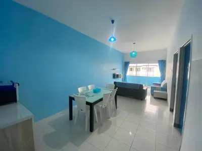a living room with a table and a couch at The Sky - The Cave Guest House in Tanah Rata