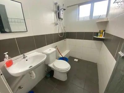 a bathroom with a toilet and a sink at The Sky - The Cave Guest House in Tanah Rata