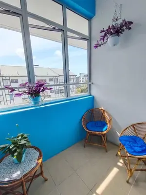 a room with two chairs and a window at The Cave - Adults Only in Tanah Rata