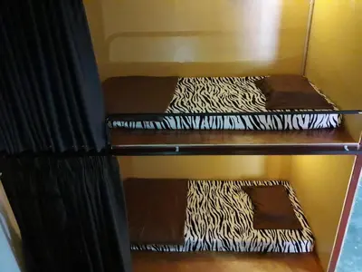 two sets of bunk beds in a room at The Cave - Adults Only in Tanah Rata