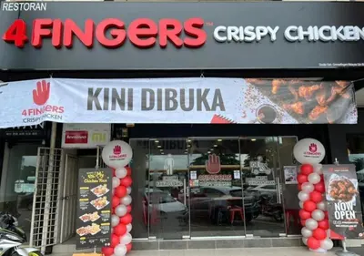 a fast food restaurant with a sign on the front of it at Marvel Cinematics Homes@ Station 18 , Ipoh in Ipoh