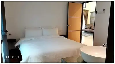 a bedroom with a white bed and a sink at Mary's Residence Ipoh in Ipoh