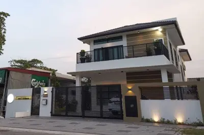 a large white house with a black gate at Mary's Residence Ipoh in Ipoh
