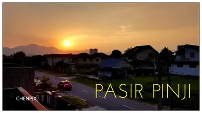a car driving down a road with the sunset in the background at Mary's Residence Ipoh in Ipoh