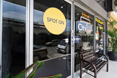 a store window with a bench in front of a store at Hotel O City Hostel Ipoh in Ipoh