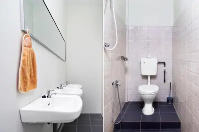 a white bathroom with a sink and a toilet at Hotel O City Hostel Ipoh in Ipoh