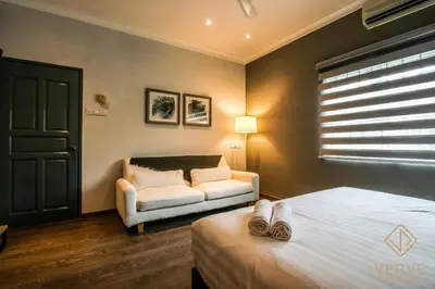 a bedroom with a bed and a couch and a window at L&P Boutique Residence by Verve (14 Pax) EECH40 in Ipoh