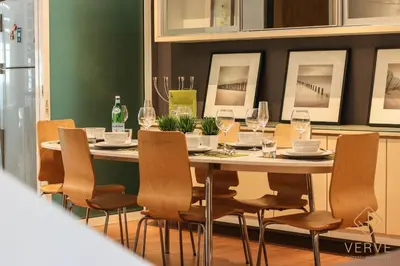 a dining room table with chairs and wine glasses at L&P Boutique Residence by Verve (14 Pax) EECH40 in Ipoh