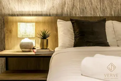 a bedroom with a white bed with a plant on a table at L&P Boutique Residence by Verve (14 Pax) EECH40 in Ipoh