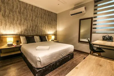 a bedroom with a bed and a desk and a mirror at L&P Boutique Residence by Verve (14 Pax) EECH40 in Ipoh