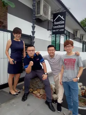 a group of people standing in front of a building at Austin Homestay in Ipoh