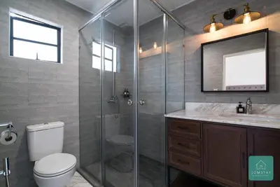 a bathroom with a shower and a toilet and a sink at Jomstay Mayhaven Villa (Ipoh) in Ipoh