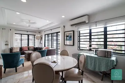 a living room with a table and chairs and a couch at Jomstay Mayhaven Villa (Ipoh) in Ipoh