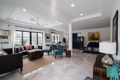 a living room with a couch and chairs and a piano at Jomstay Mayhaven Villa (Ipoh) in Ipoh