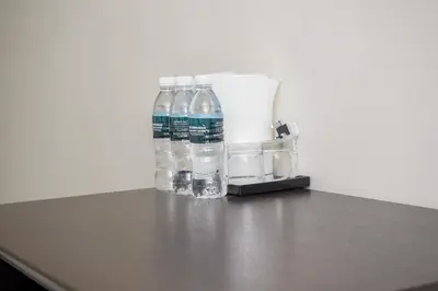 a group of water bottles sitting on top of a counter at DCozy Hotel in Perai