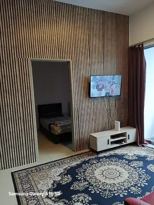 a living room with a bed and a mirror at Galina Somersquare Goldenhills Aprt Pasar Malam Cameron Highlands in Brinchang