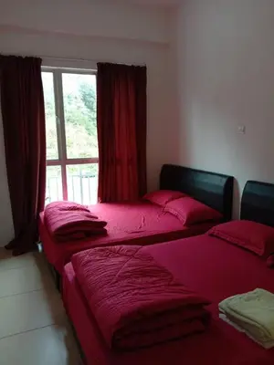 three beds in a room with a window at Galina Somersquare Goldenhills Aprt Pasar Malam Cameron Highlands in Brinchang