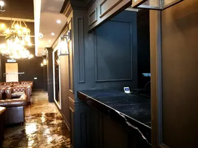 a dark room with a bar with a couch at CJ HOUSE station 18 Ipoh in Ipoh