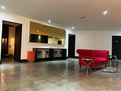 a living room with a red couch and a counter at CJ HOUSE station 18 Ipoh in Ipoh