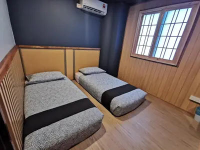a room with two beds and a window at Tatami D'Tepi Laut - PANGKOR ISLAND in Pangkor