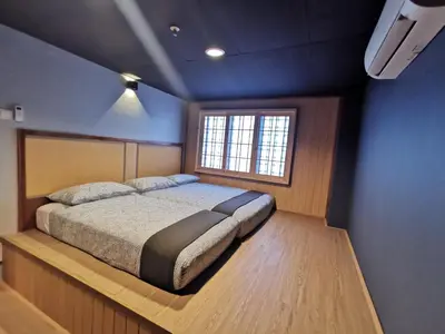 a bedroom with a bed and a window in it at Tatami D'Tepi Laut - PANGKOR ISLAND in Pangkor