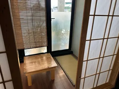 a room with a wooden bench and two windows at Tatami D'Tepi Laut - PANGKOR ISLAND in Pangkor
