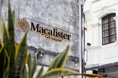 a sign on the side of a building at Macalister Terraces Hotel in George Town