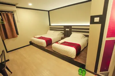 a room with two beds in a room at HOTEL PREMIUM in Ipoh