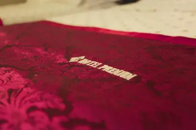 a red blanket with a tag on top of it at HOTEL PREMIUM in Ipoh