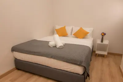 a bed with a white stuffed animal sitting on it at Cameron Highlands Modern7-Tea Plantation View-Premium Hotel Bed in Kampung Kuala Terla