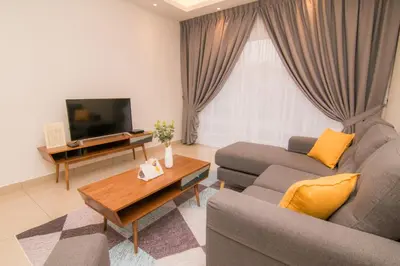 a living room with a couch and a tv at Cameron Highlands Modern7-Tea Plantation View-Premium Hotel Bed in Kampung Kuala Terla