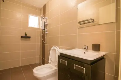 a bathroom with a white toilet and a sink at Cameron Highlands Modern7-Tea Plantation View-Premium Hotel Bed in Kampung Kuala Terla