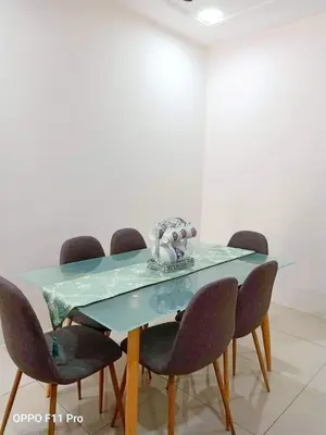 a dining room table with four chairs around it at Rara Homestay Kuala Kangsar in Kuala Kangsar